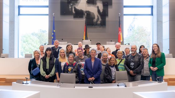 Das Asphalt-Team mit der Landtagspräsidentin und Fraktionsmitgliedern unter dem Niedersachsenross im Plenarsaal.