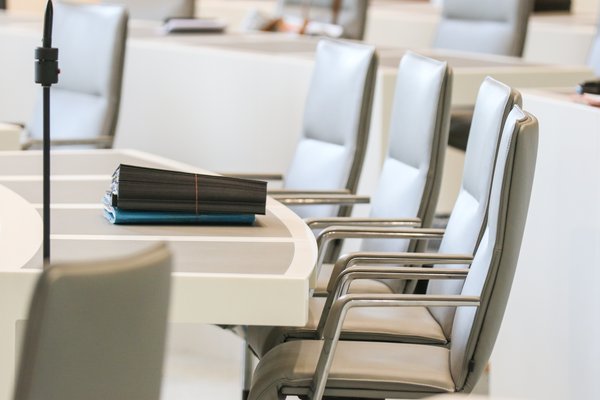 Leere Stühle im Plenarsaal