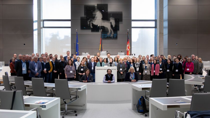 Gruppenfoto der Teilnehmenden des Verbandstages der Parlaments- und Verhandlungsstenografen mit Landtagspräsidentin Hanna Naber im Plenarsaal