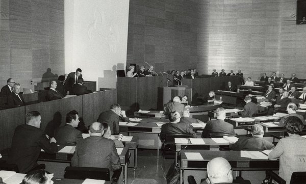 Bild: © Archiv des Niedersächsischen Landtages/Fotograf: unbekannt In Bildmitte die Präsidiumsbank mit (v.l.n.r.) Schriftführerin Hilde Obels-Jünemann (SPD), Landtagspräsident Wilhelm Baumgarten (SPD) und Schriftführer Friedrich Greve (CDU), rechts daneben die Regierungsbank mit Ministerpräsident Dr. Georg Diederichs und Kultusminister Richard Langeheine.