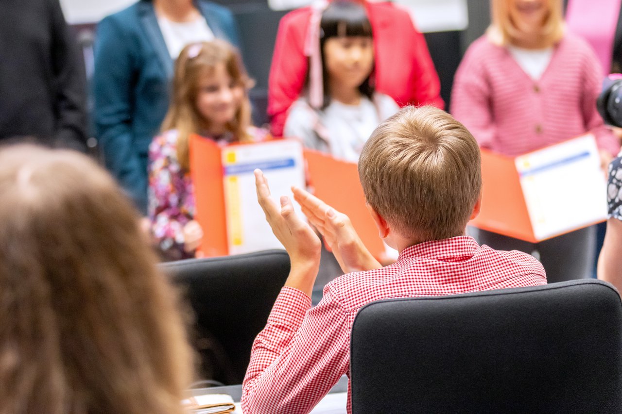 Schülerinnen und Schüler präsentieren ihre Urkunden.