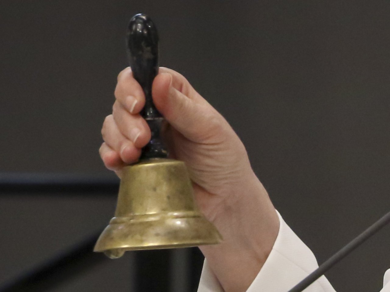 The Speaker of the State Parliament uses a bell to bring the plenary session to order. 
